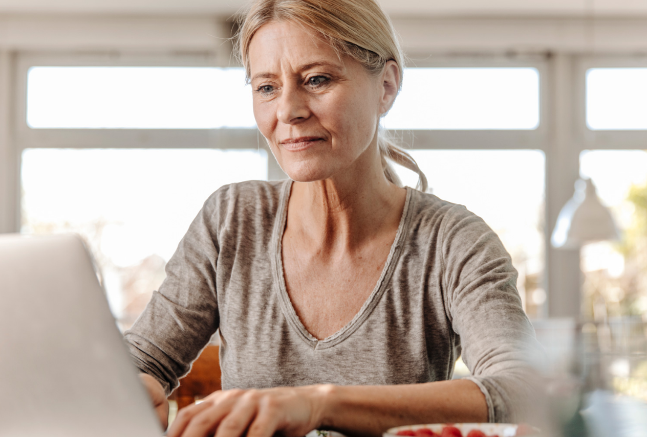 late-middle aged woman searching on laptop