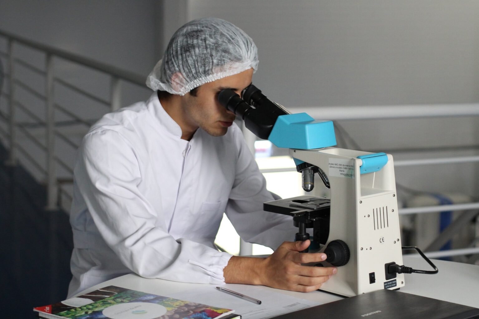 image of male researcher looking into a microscope
