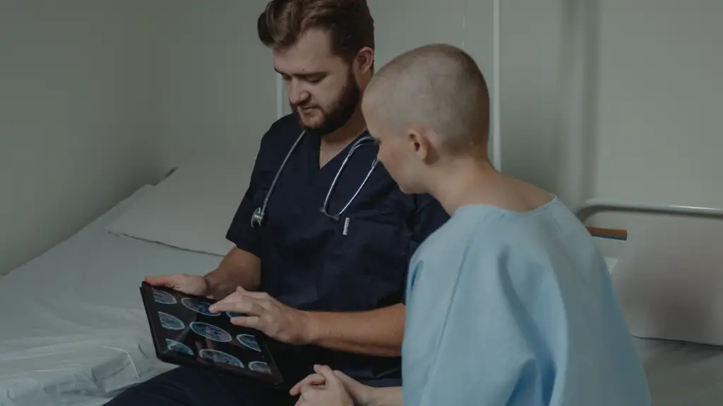 A doctor speaking with a patient and looking at scans.