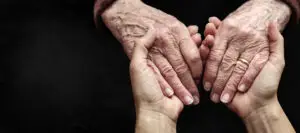 A close up of two hands holding on to each other.