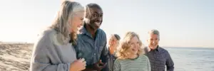 group of elderly people walking on the beach