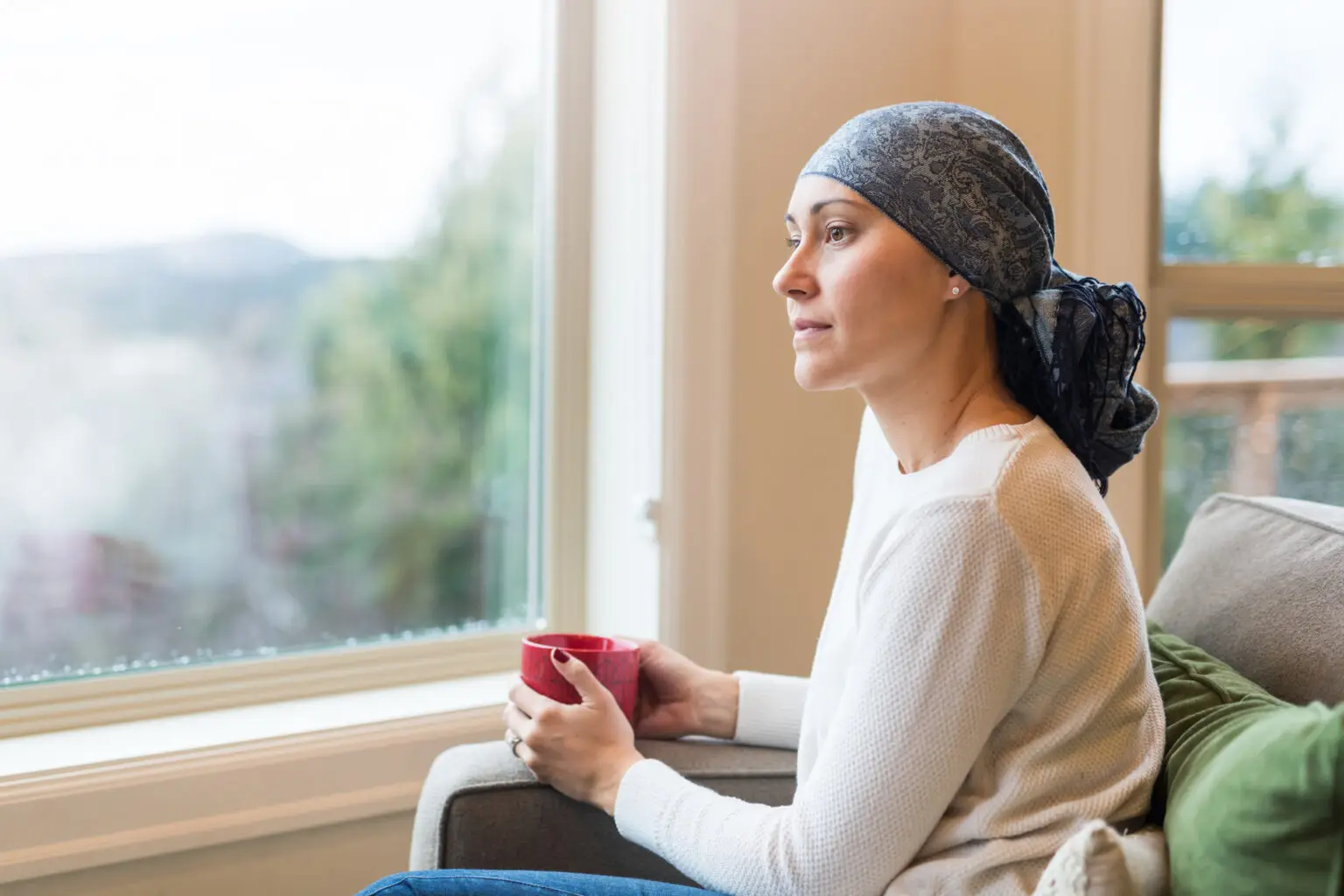 female breast cancer patient sitting with a mug