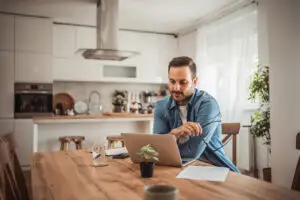 man on his laptop in the kitchen