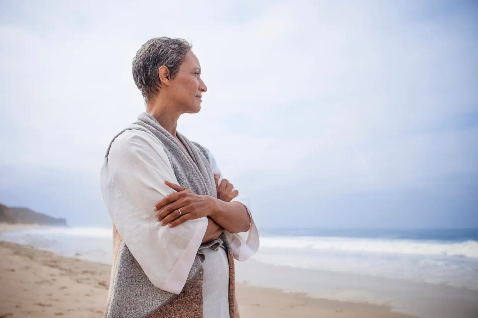 older woman overlooking the ocean side profile