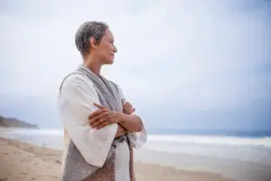 older woman overlooking the ocean side profile