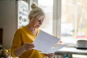 woman filling out financial statements at home