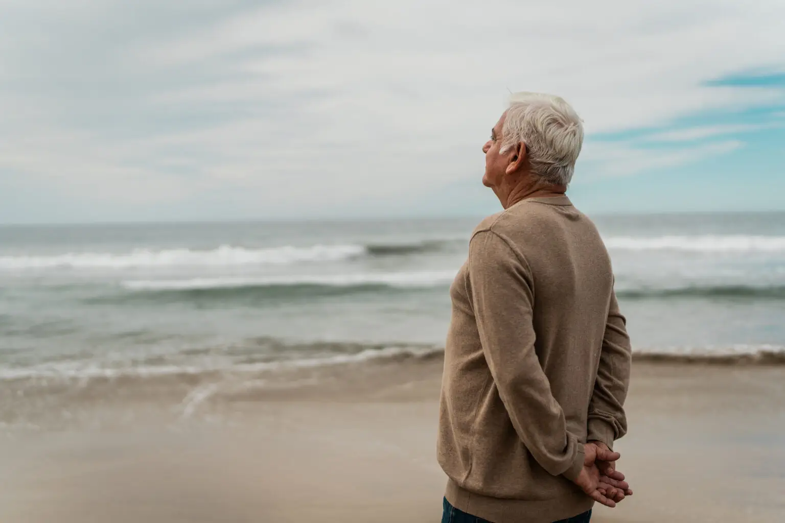 Senior man looking away contemplating at beach