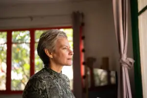 woman looking through the view at home thinking