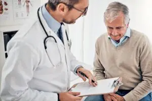 Doctor consulting with a older patient in his office