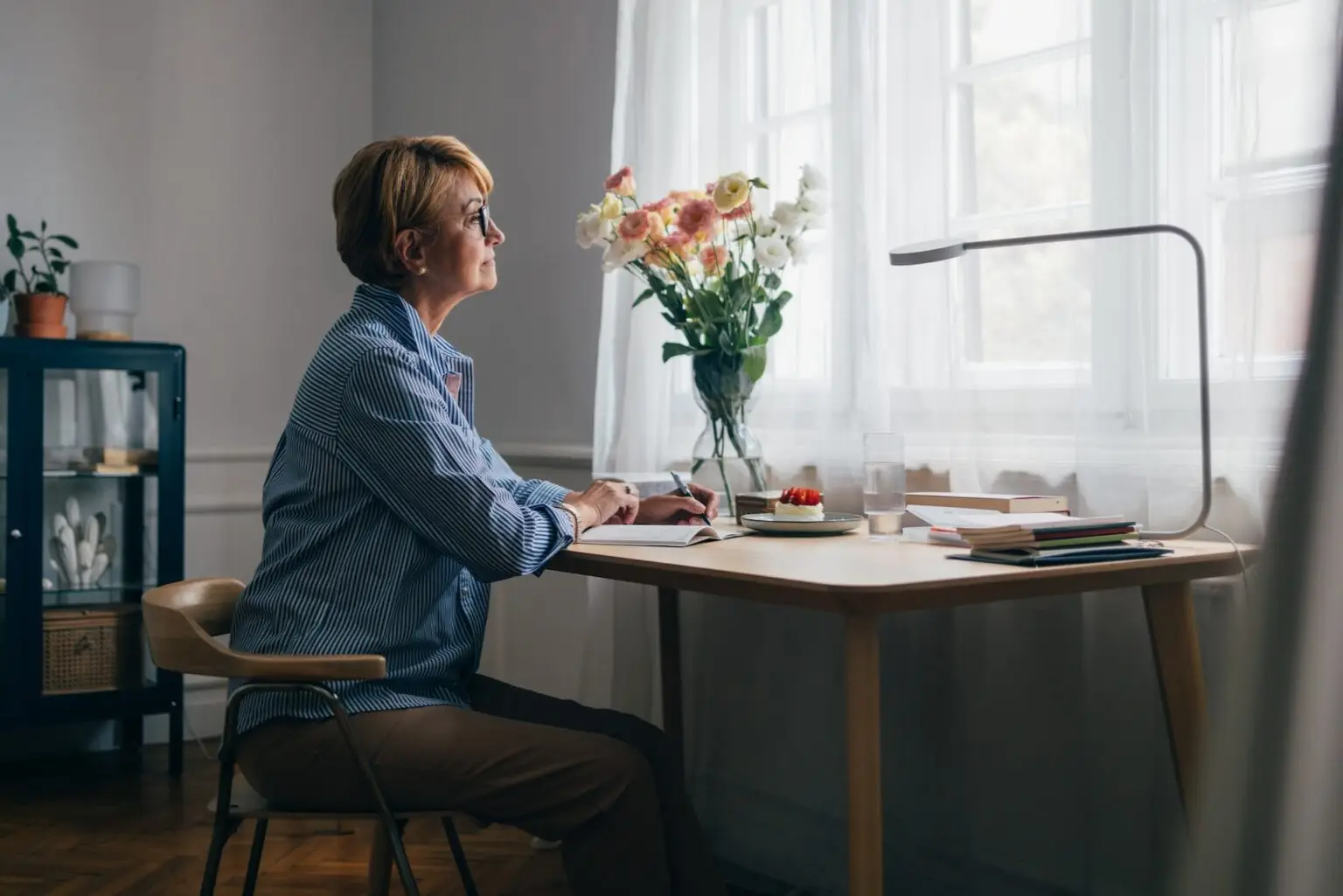 woman sitting at her desk thinking