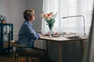 woman sitting at her desk thinking