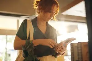 Woman reading the label of a food product in a grocery store