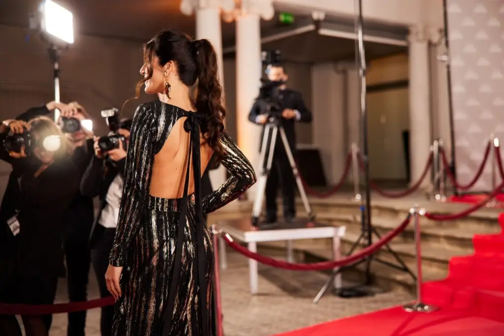 celebrity on the red carpet with papparazis