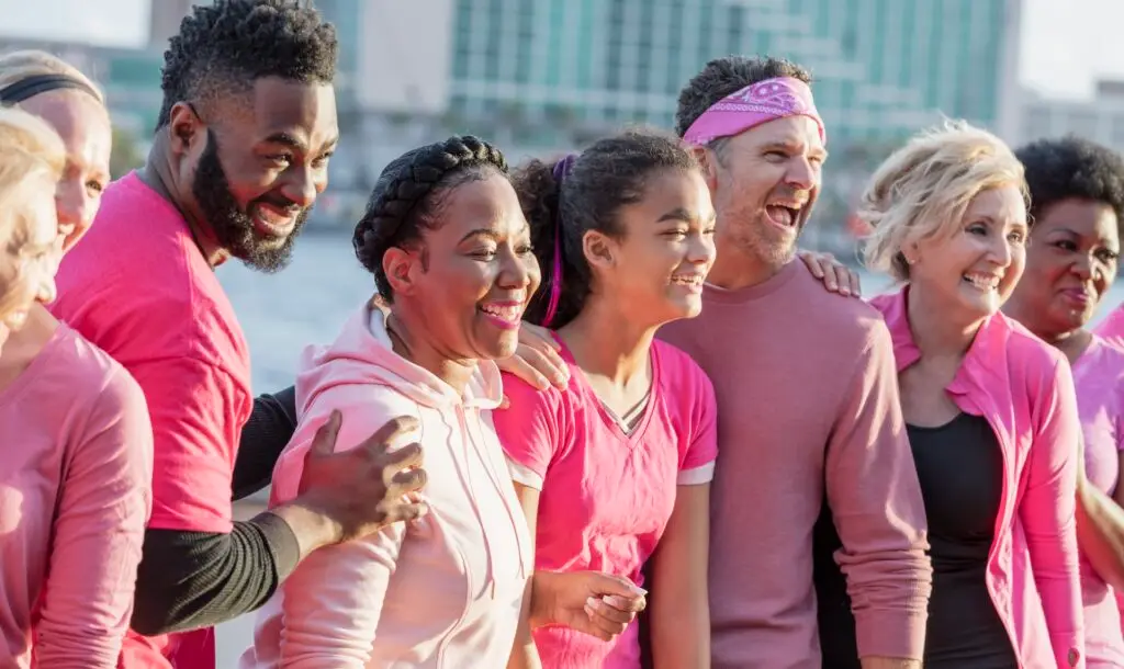 Group of men and women in pink, at breast cancer rally