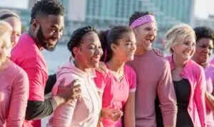 Group of men and women in pink, at breast cancer rally