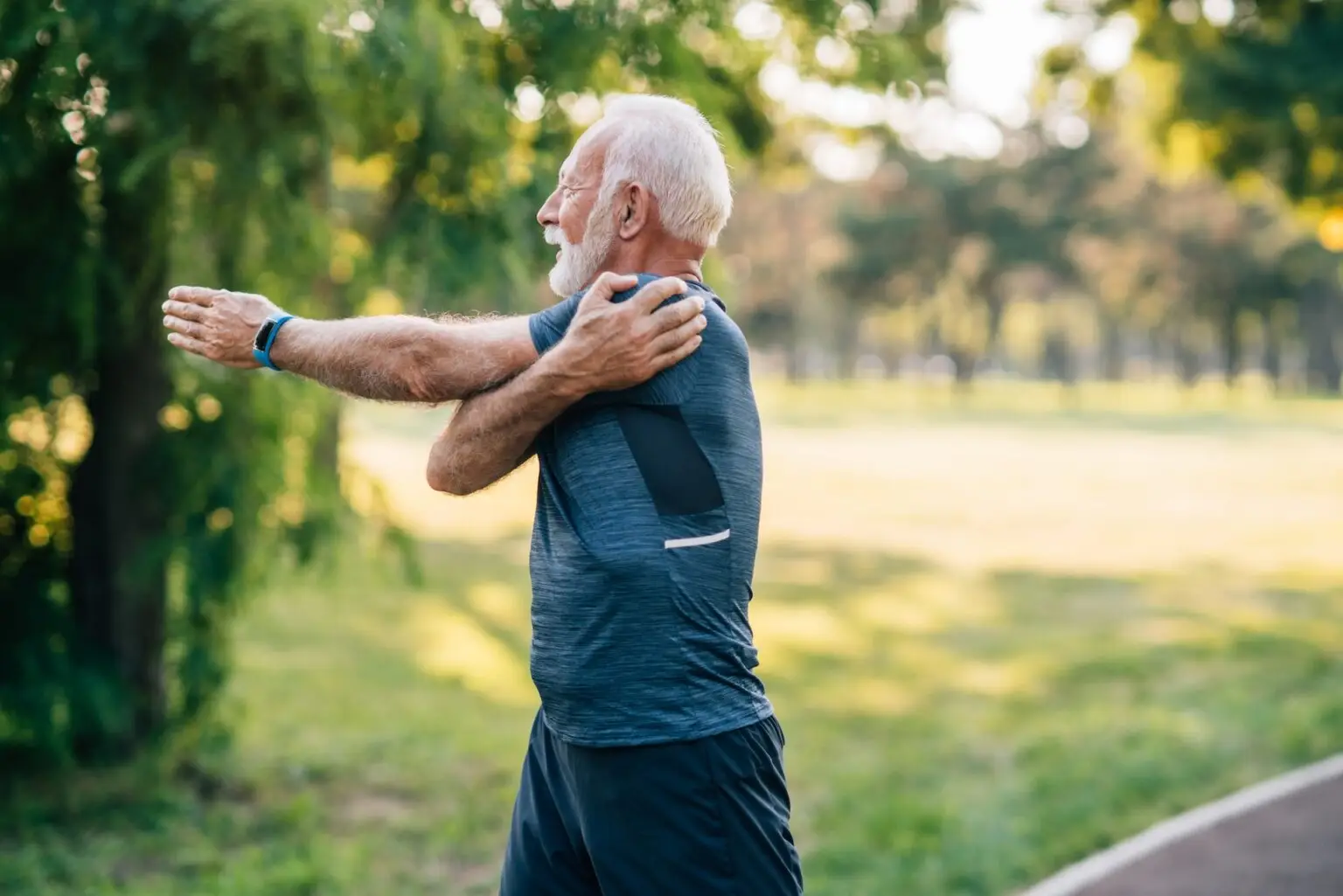 athletic older man stretching outside