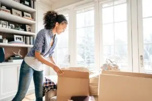 woman organizing living bright living room with boxes