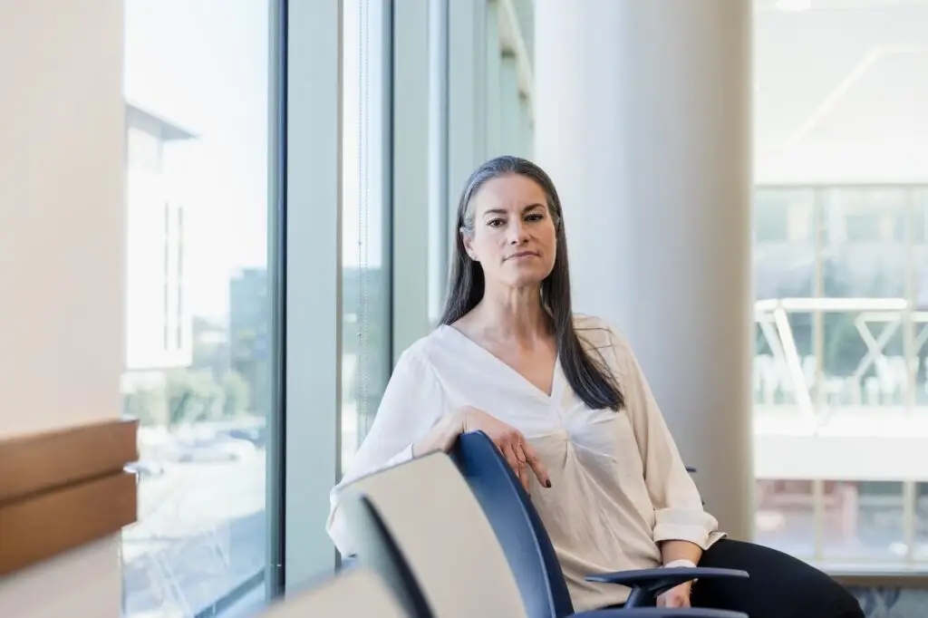 woman sitting in the waiting looking at the camera