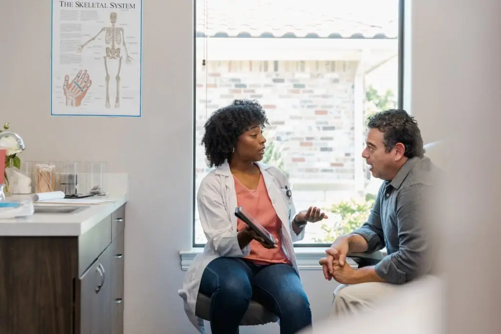 Doctor speaking with male patient in office