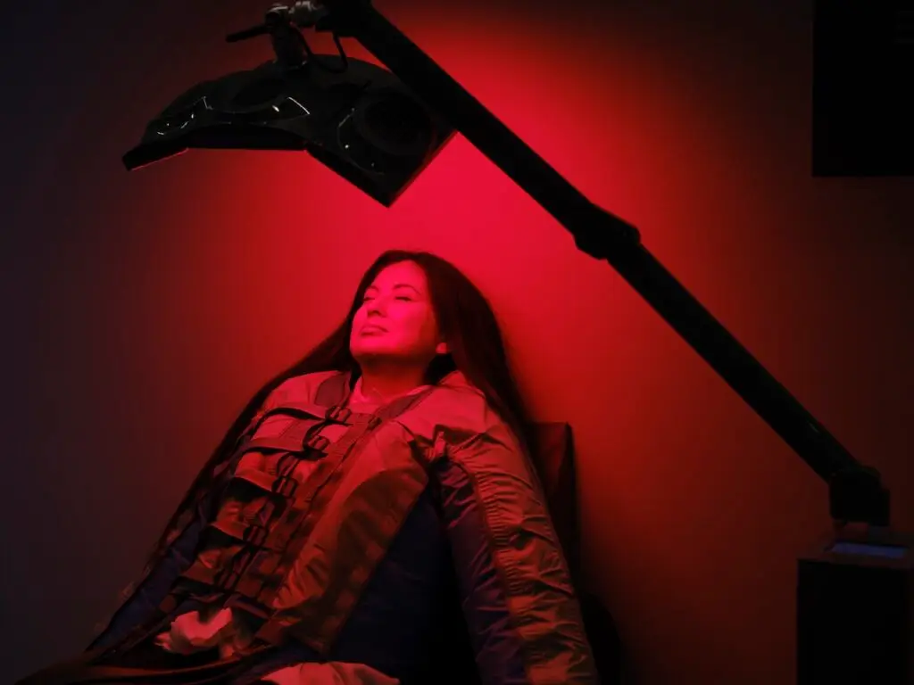 Woman On an LED Bed Receiving Red Light Therapy
