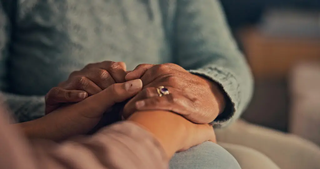 close up of comforting hands at home