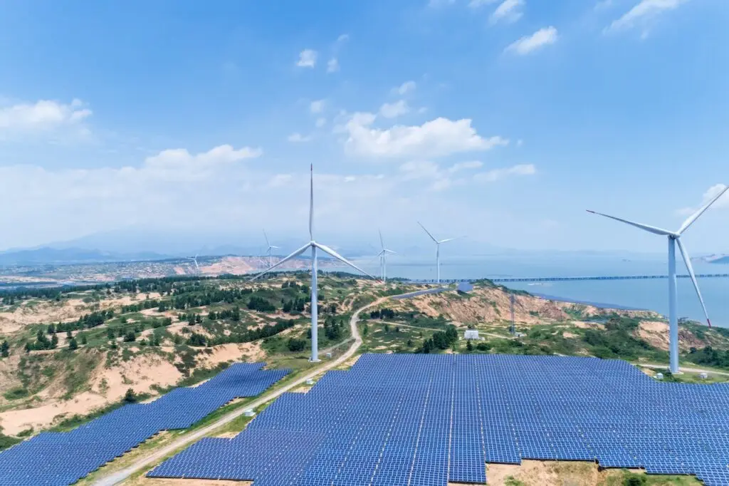 new energy by lakeside, wind farm and solar power with sunny sky