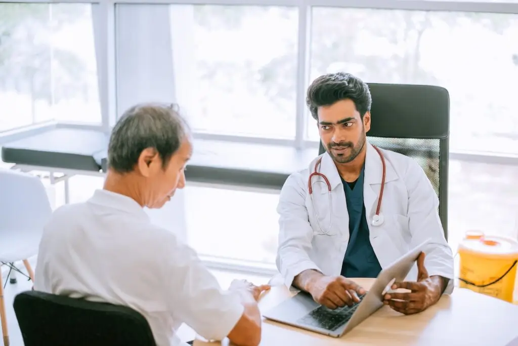 doctor consulting with older male patient at the clinic