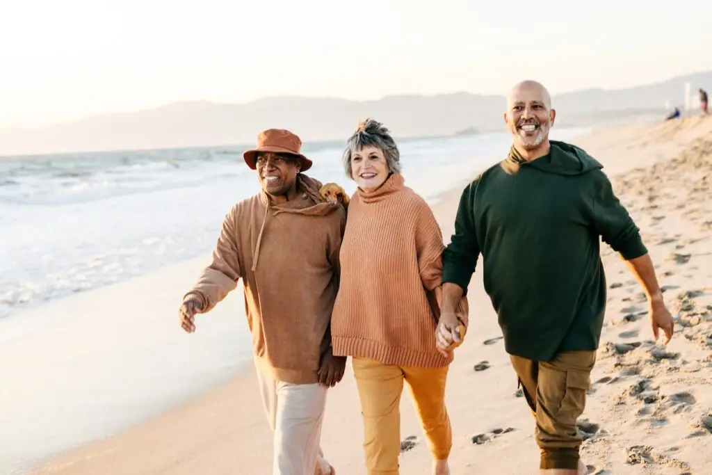 group of friends walking on the beach