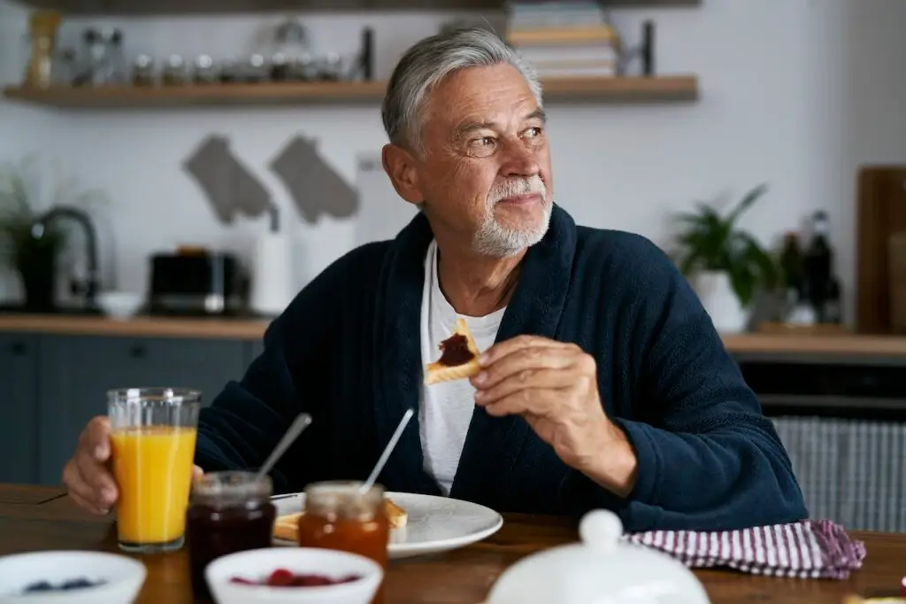 man eating breakfast at home