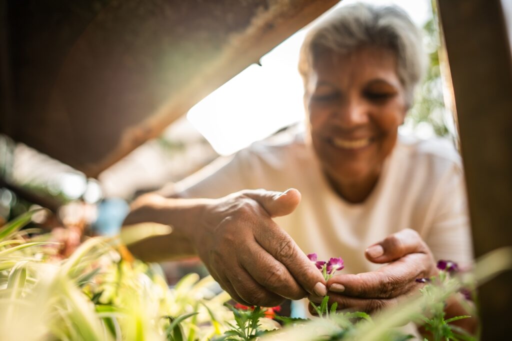 Close-up of a woman choosing flowers at a garden center
