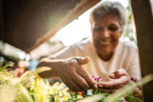 Close-up of a woman choosing flowers at a garden center