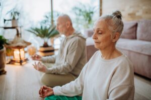 couple meditating together in their living room during