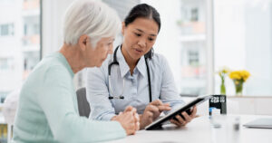 woman talking to her doctor reviewing results on tablet