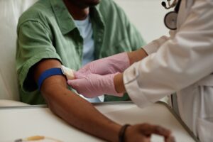 Close up nurse preparing patient for blood test