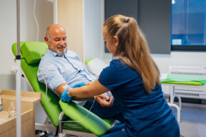 Female doctor collecting patient's blood sample for test in medical clinic