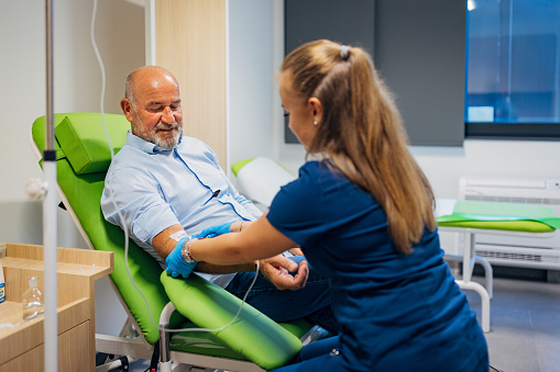 Female doctor collecting patient's blood sample for test in medical clinic