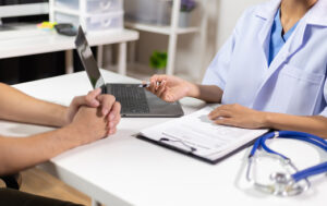 Doctor giving advice on treatment to patients in hospital examination rooms, treatment diseases from specialists. Medical treatment and health consultation.