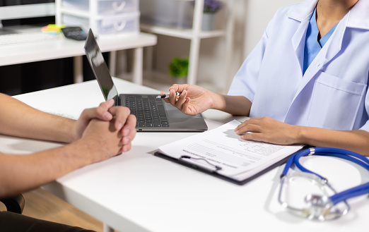 Doctor giving advice on treatment to patients in hospital examination rooms, treatment diseases from specialists. Medical treatment and health consultation.