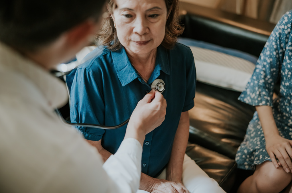 Doctor using stethoscope to hear patients lungs.