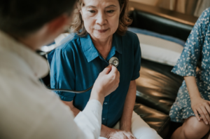 Doctor using stethoscope to hear patients lungs.