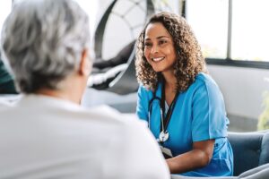 Healthcare professional talking to patient at home