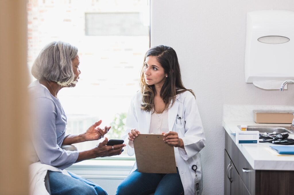 Caring doctor listening to patient