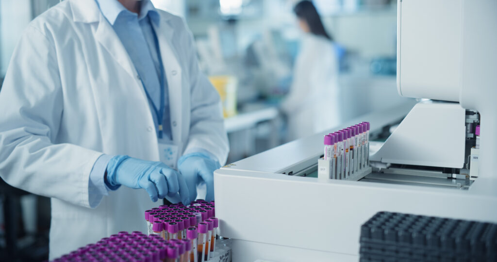 Close Up on Anonymous Female Scientist Working in a Sterile Environment in Modern Healthcare Facility.