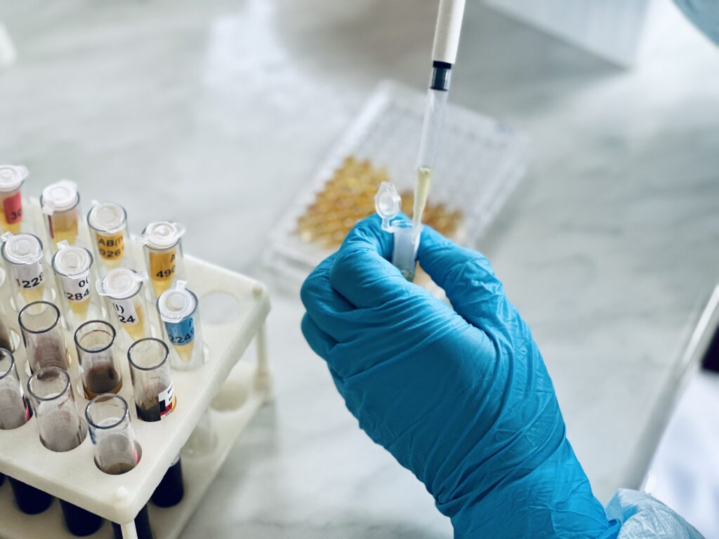Filling 96 well plate for microbiological analysis by pipette.