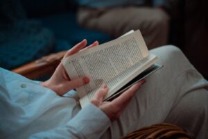 Person Sitting With An Open Book