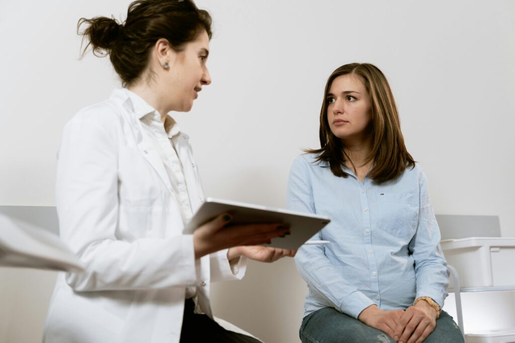 Female doctor and patient discussing treatment.