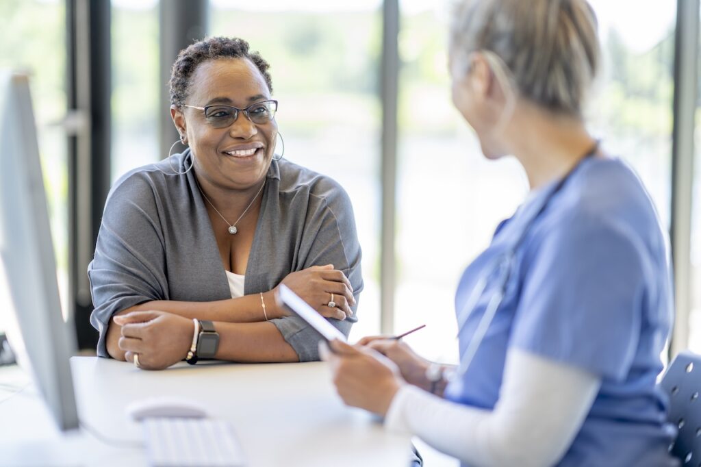 woman speaking to a nurse at the clinic