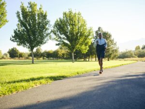 A mature black man, exercising in a park in the morning.