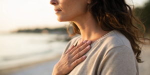 Woman concerned about breast pain without a lump, a potential sign of breast cancer.