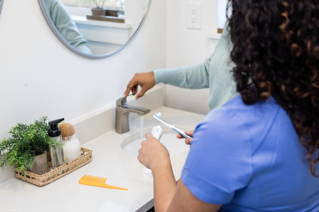 close up of sink and tooth brush getting ready to brush teeth